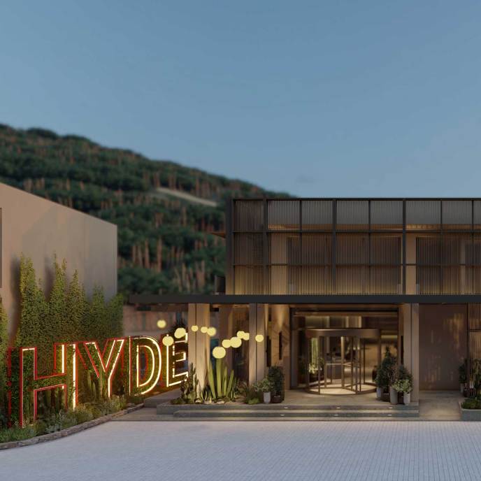 Entrance to the hotel at dusk, with large HYDE sign on the left