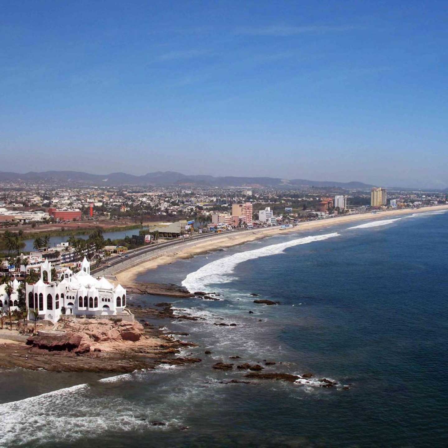 Mazaltan coastline with a long beach in front of buildings