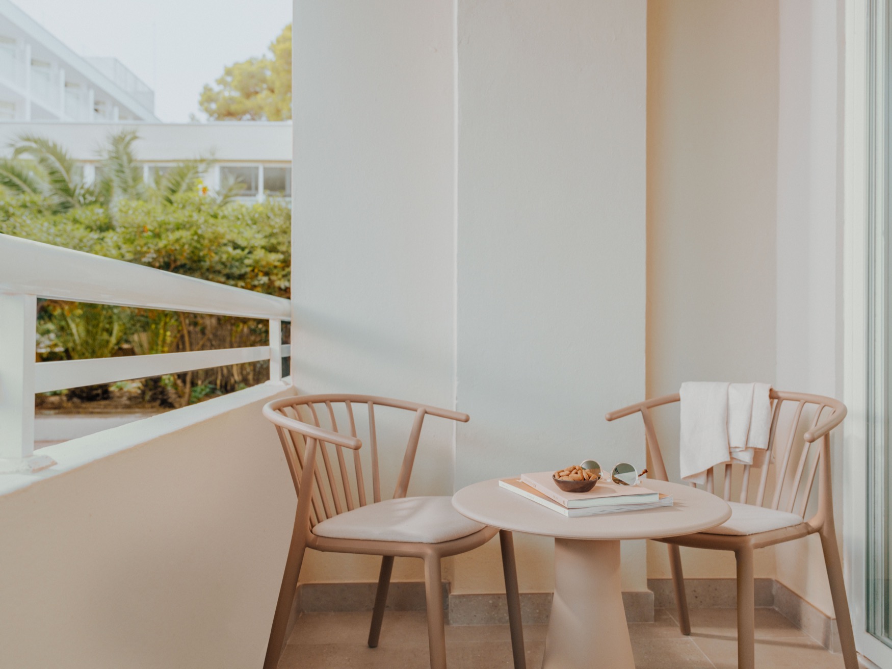 A view from the balcony with 2 chairs and a coffee table