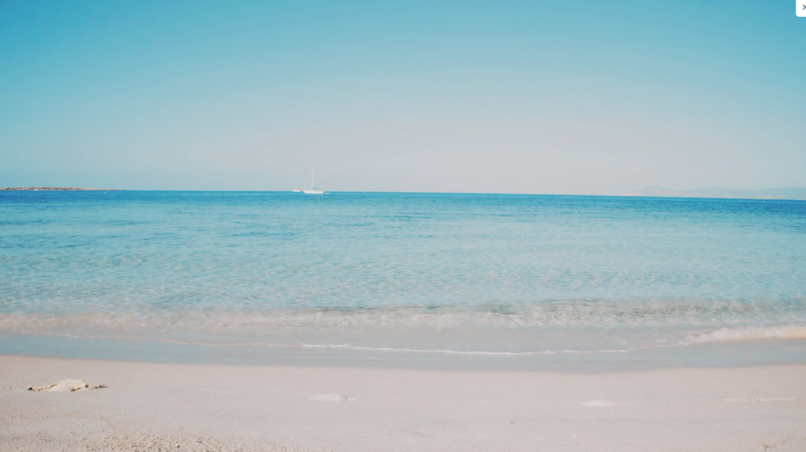 A view point from the white sand beach looking into the blue ocean and clear sky.