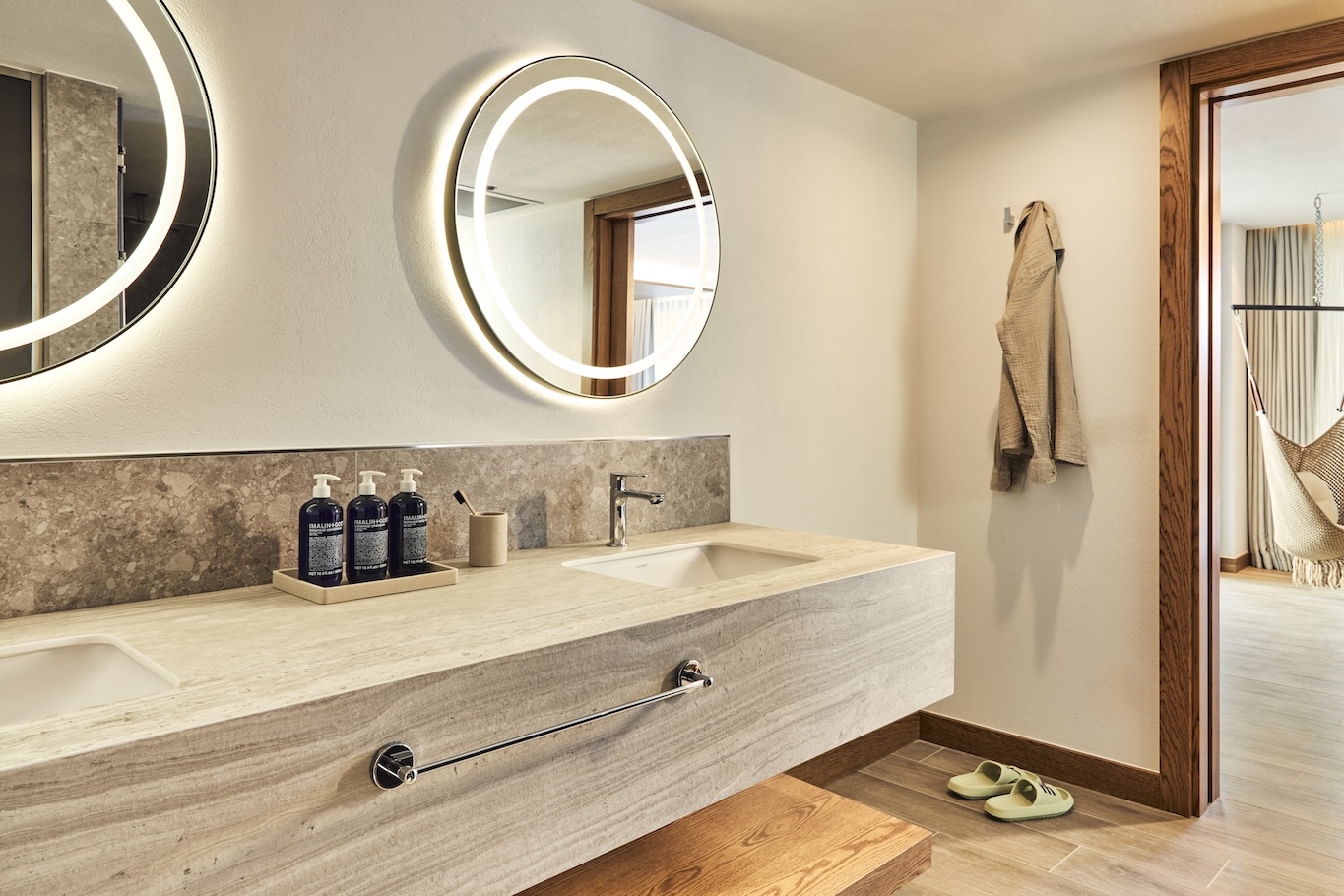 Large double bathroom grey sink with two circular mirrors above