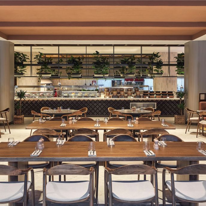 Two large rectangular tables with rows of chairs