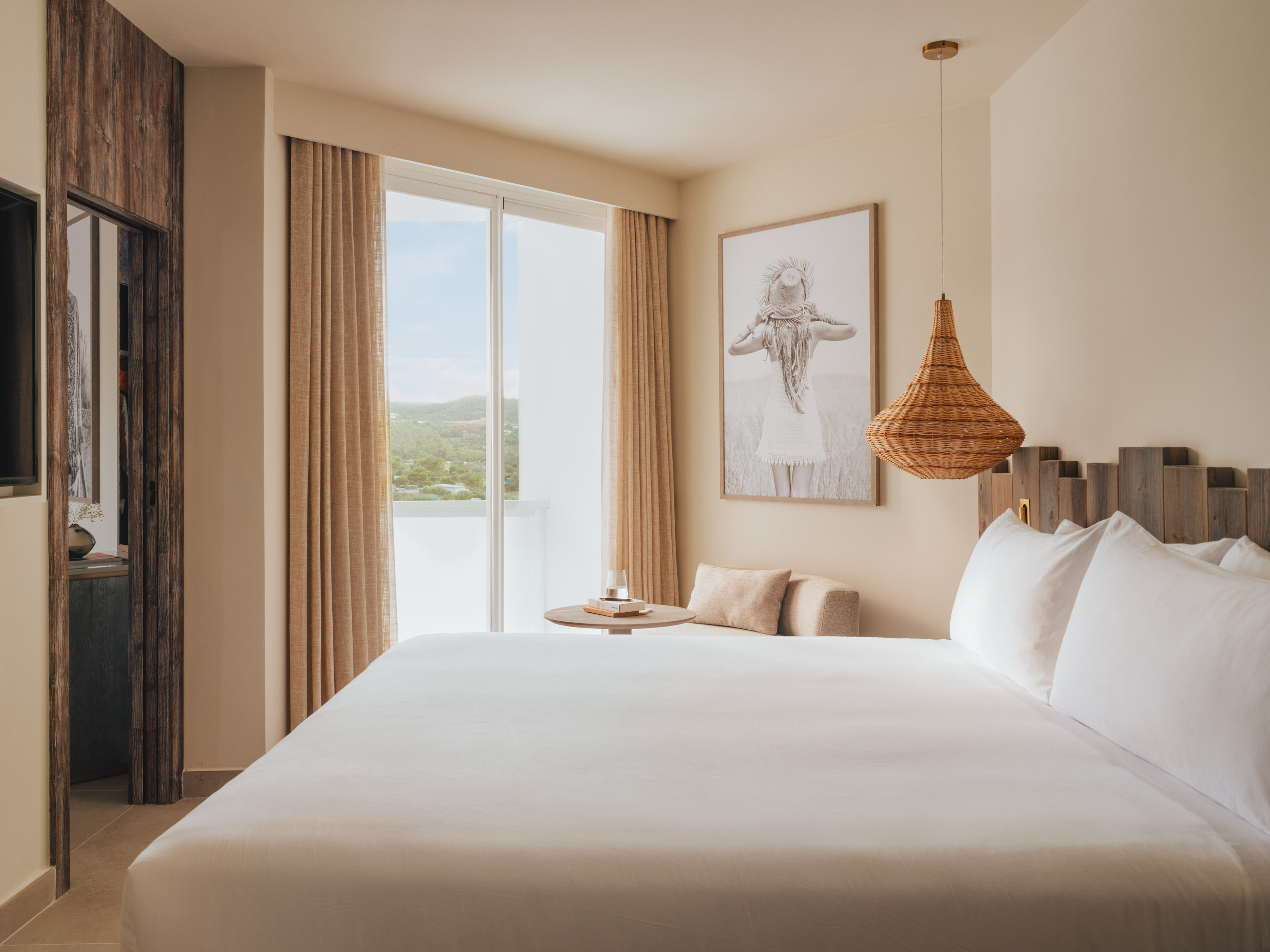 A large bed with doors leading outside