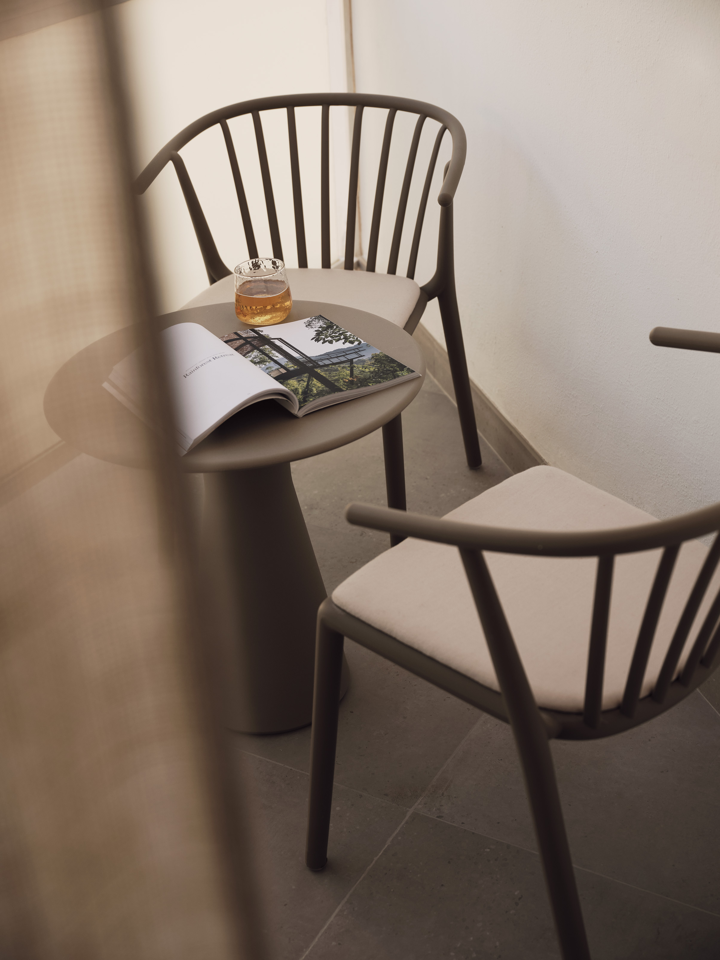 Two chairs next to a round table with open book