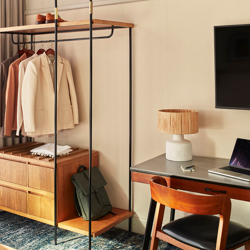 On the right, it is the desk that can be used for work or a makeup area. On the left, it is an open wardrobe, with drawers at the bottom.
