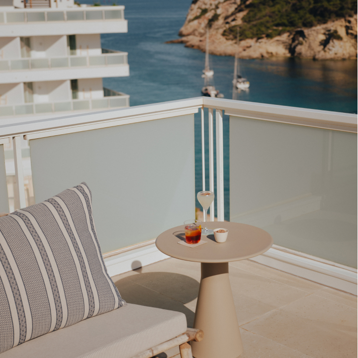 Comfy seating with stripy cushion and a sea view