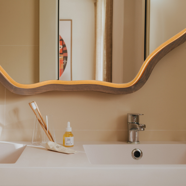 A close up of a bathroom mirror and sink