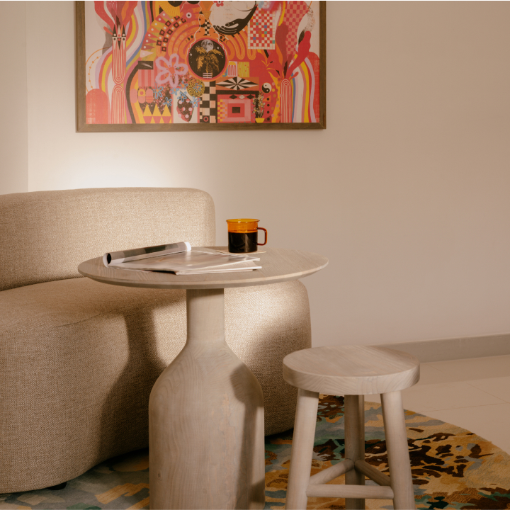 Comfy seating next to a round table and small stool