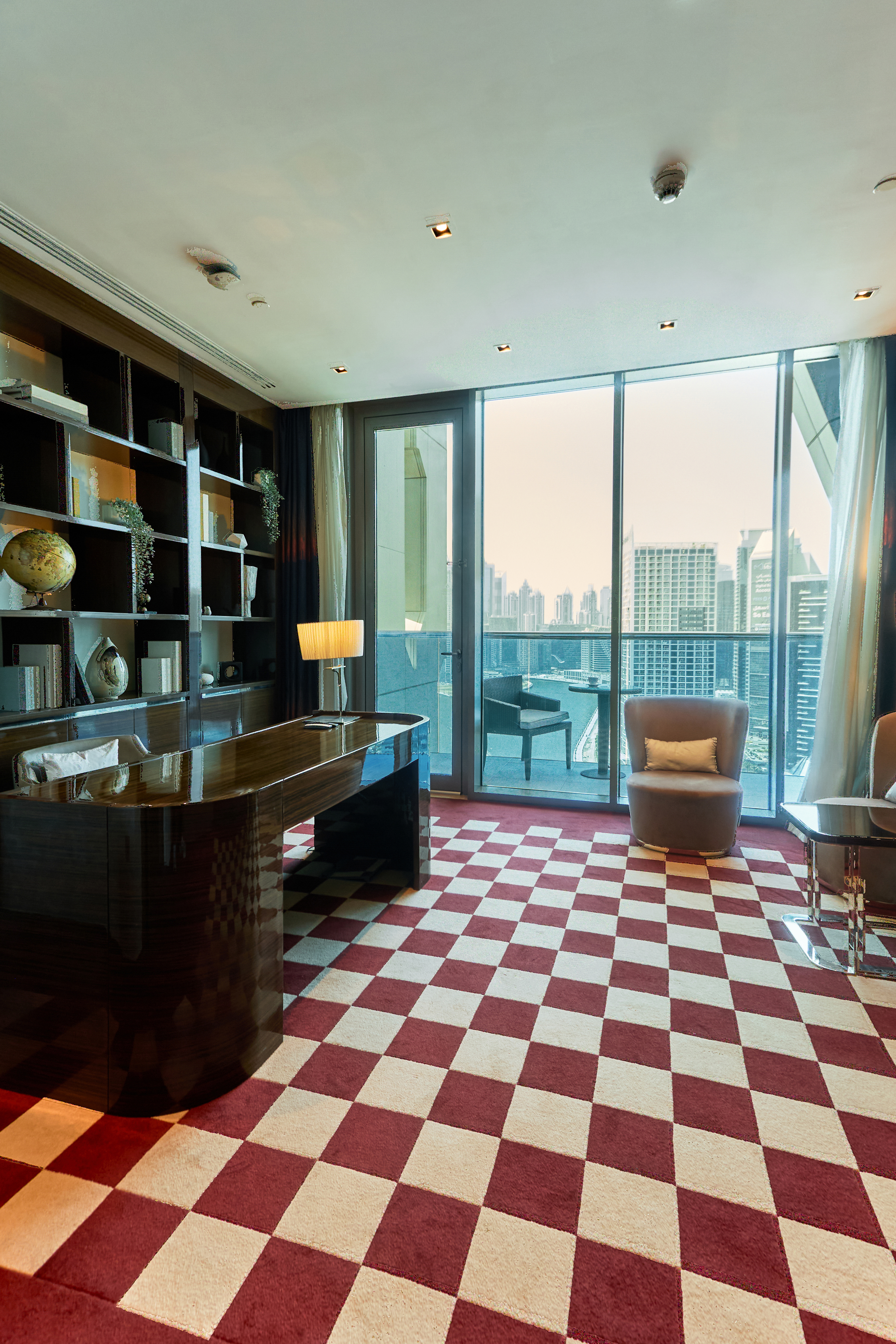 A photo of the office/study in a penthouse, showcasing the room layout with a view of the Dubai skyline